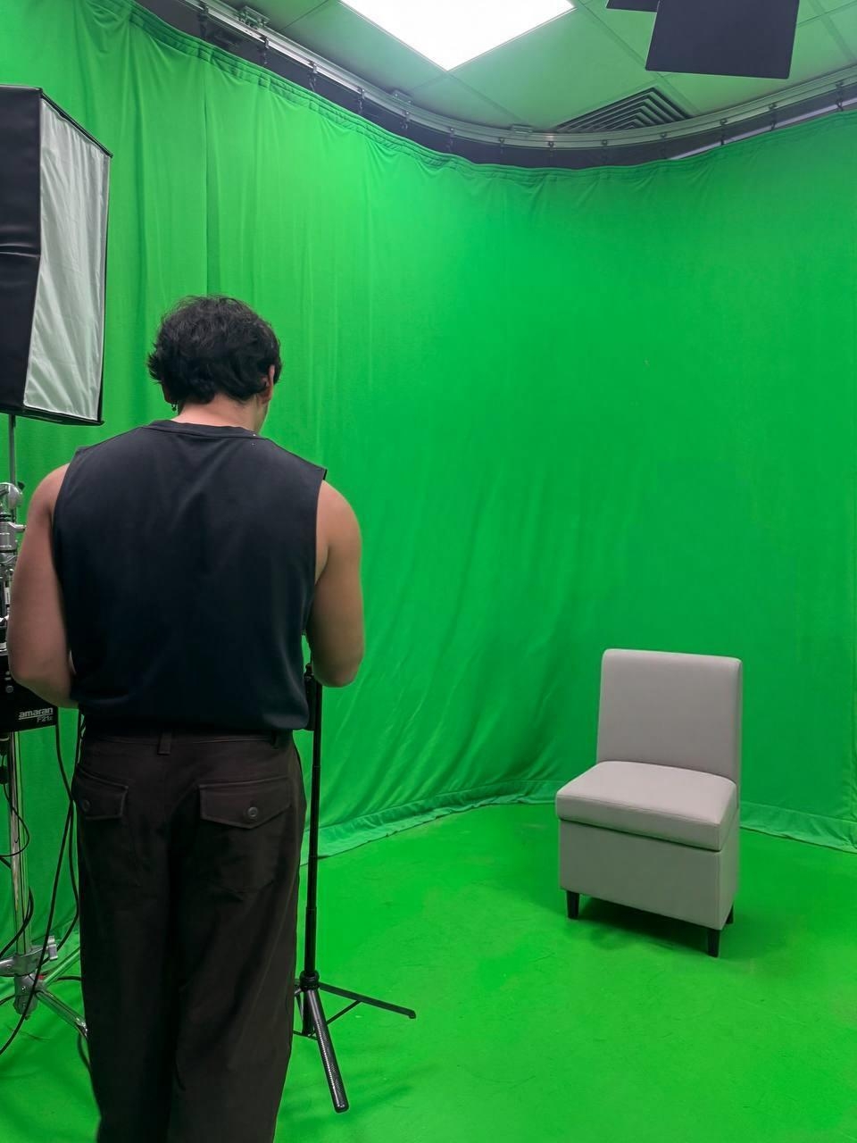 NextTake Labs founder standing beside a light in front of a green screen